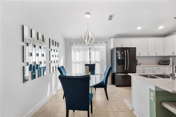 a kitchen with stainless steel appliances kitchen island granite countertop a sink a stove and refrigerator