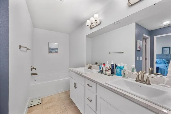 a bathroom with a tub sink and a mirror