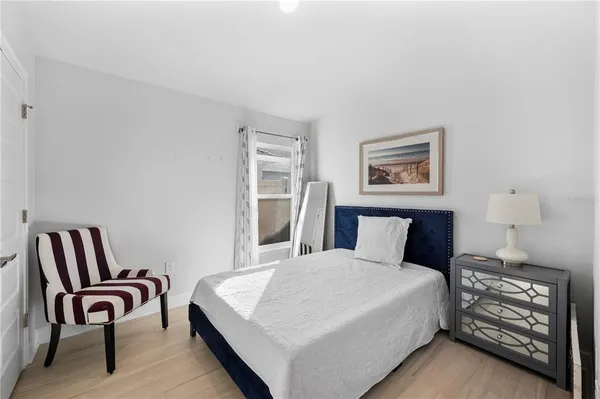 a bedroom with a bed and a rug