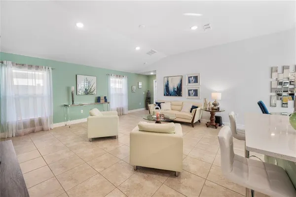 a living room with furniture and a large mirror