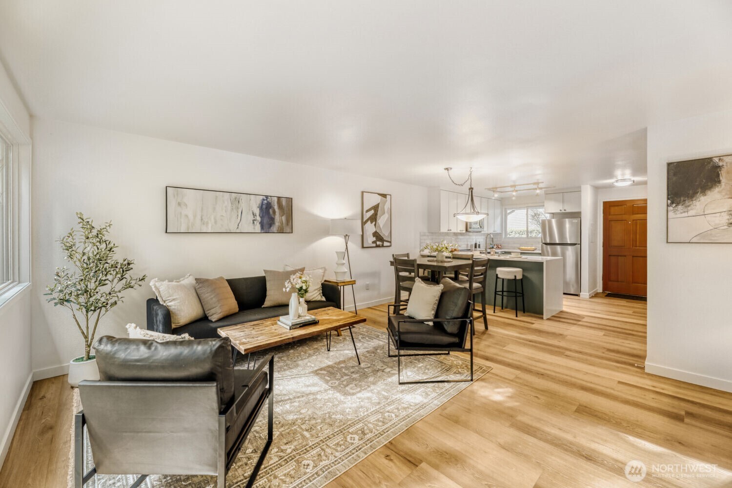 a living room with furniture and kitchen view