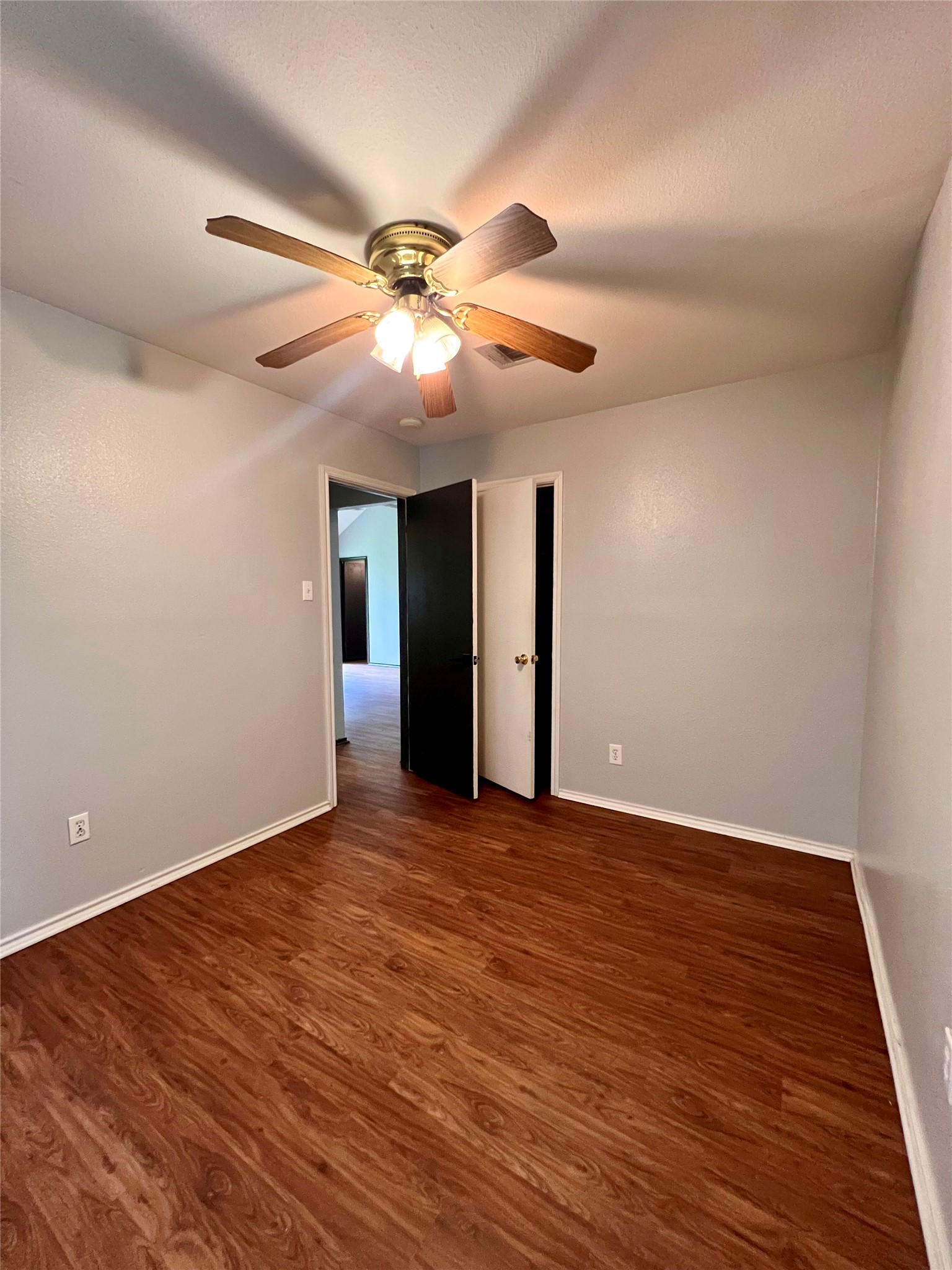 5404 China Berry Road Austin, TX 78744 - Photo 15 of 20 A comfortable bedroom with rich wood flooring provides a serene retreat.