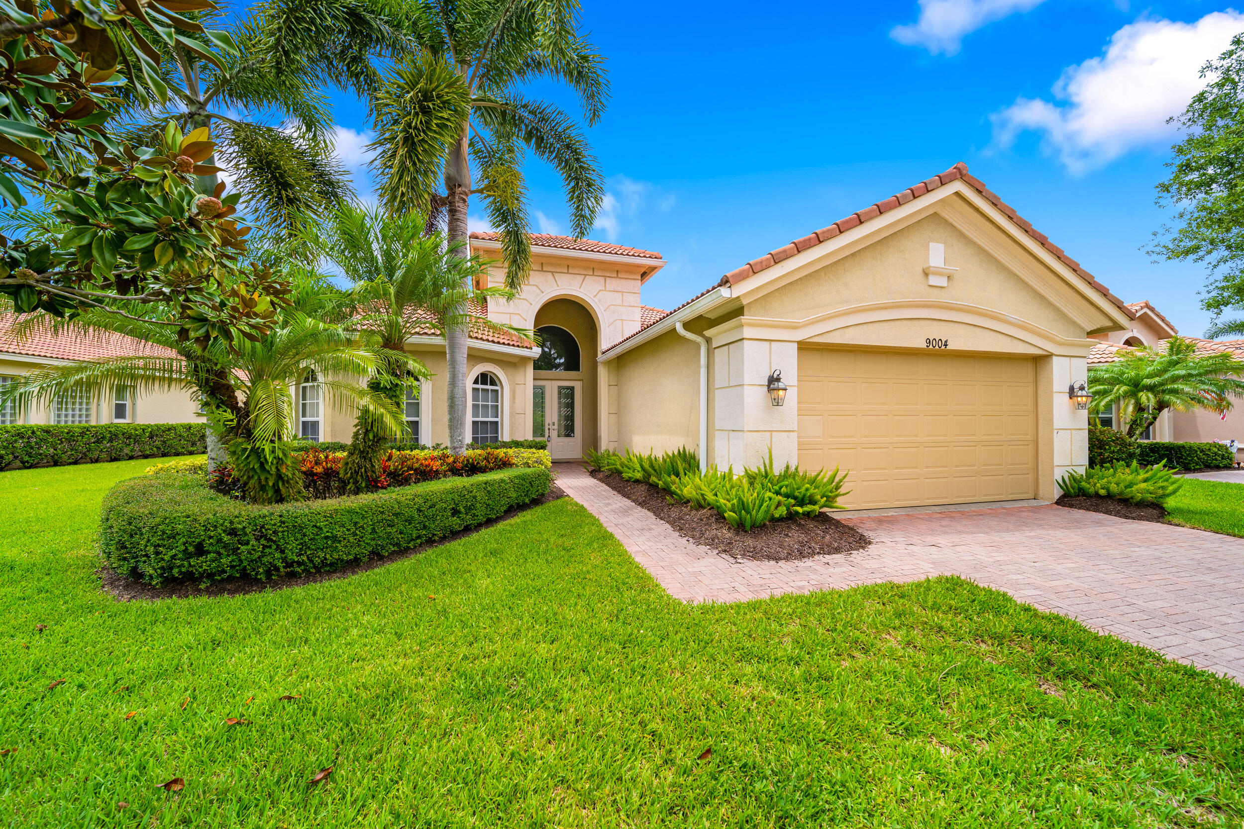 9004 Pumpkin Ridge Port St. Lucie, FL 34986 - Photo 1 of 36 a front view of a house with a yard and garage