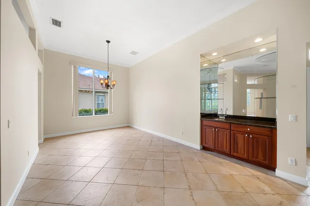 a large kitchen with granite countertop a stove a sink and a shower