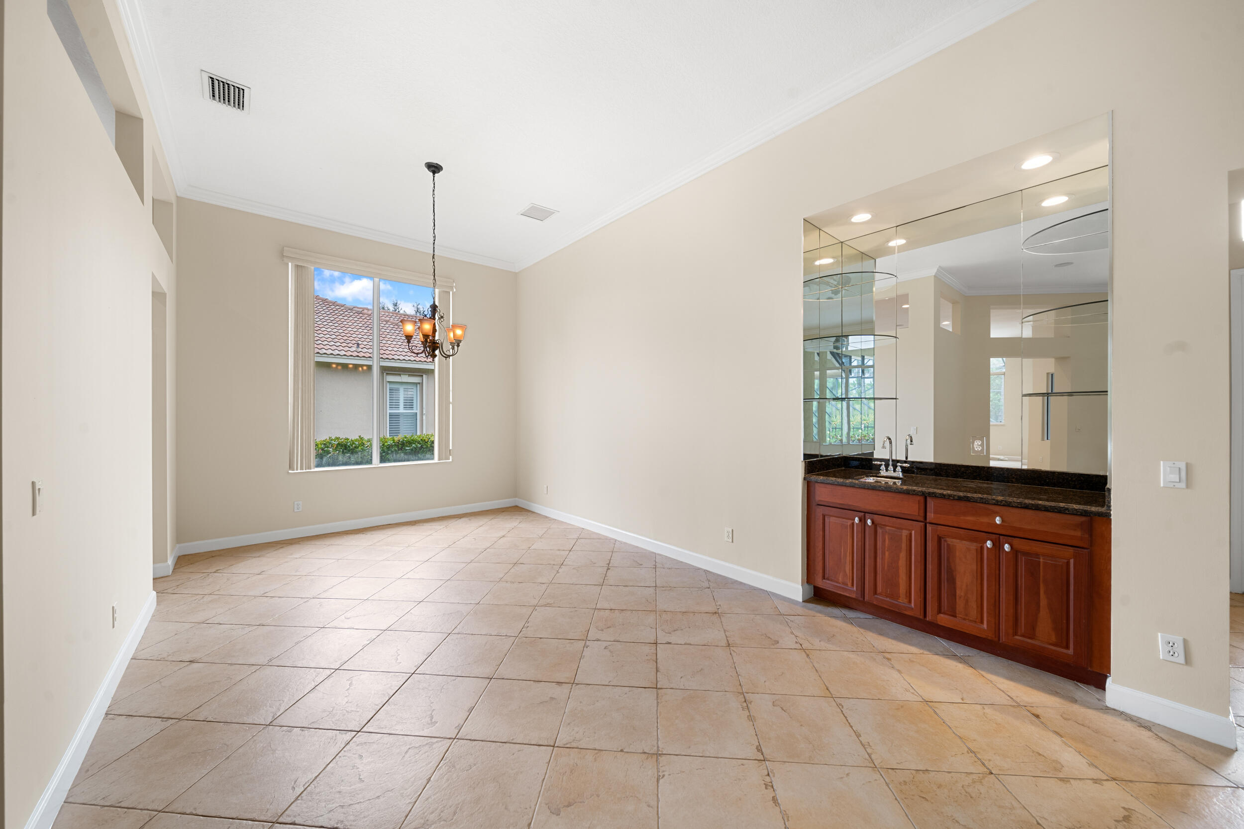 9004 Pumpkin Ridge Port St. Lucie, FL 34986 - Photo 16 of 36 a large kitchen with granite countertop a stove a sink and a shower