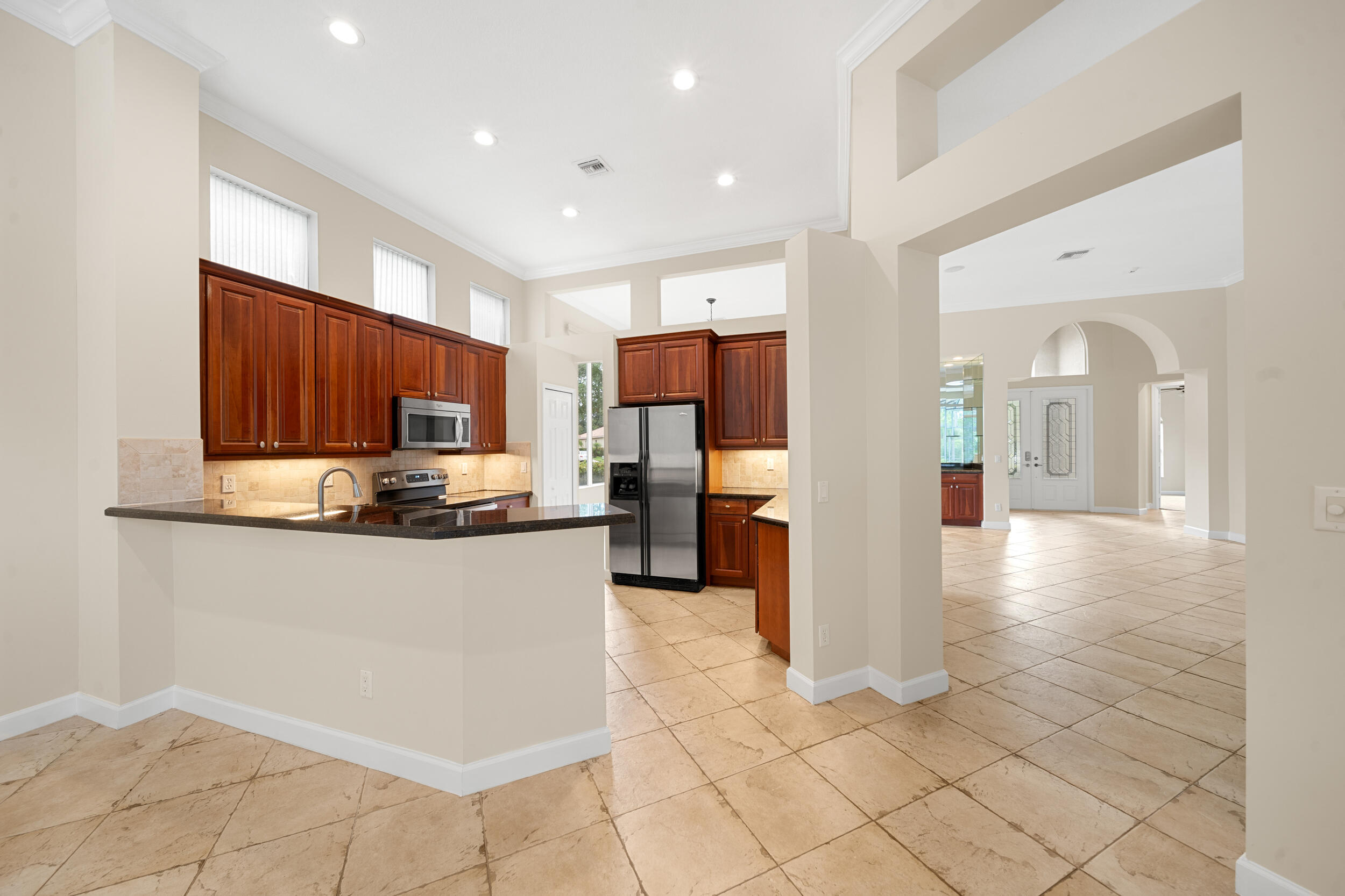 9004 Pumpkin Ridge Port St. Lucie, FL 34986 - Photo 28 of 36 a kitchen with stainless steel appliances granite countertop a refrigerator and a sink