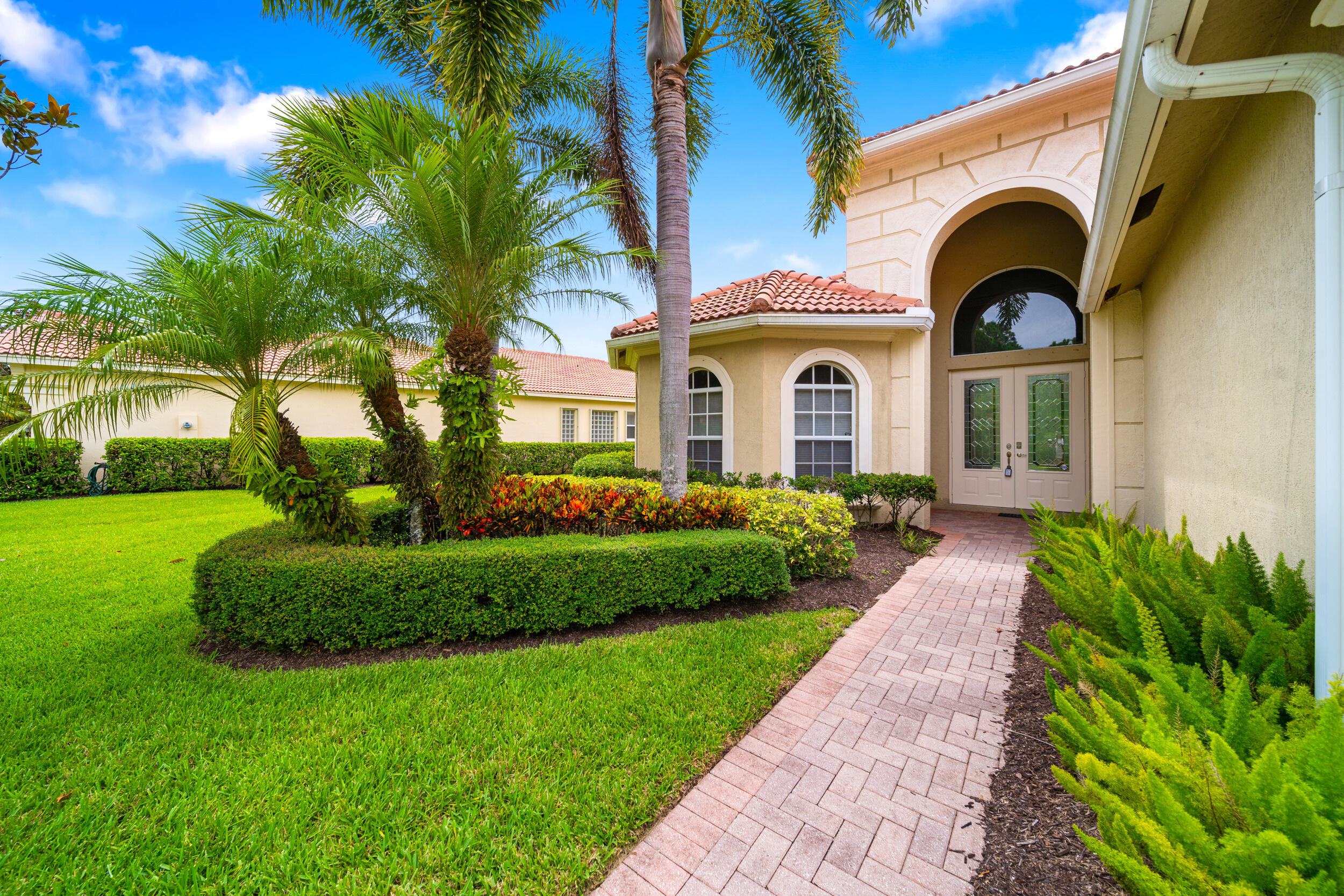 9004 Pumpkin Ridge Port St. Lucie, FL 34986 - Photo 3 of 36 a front view of a house with a garden