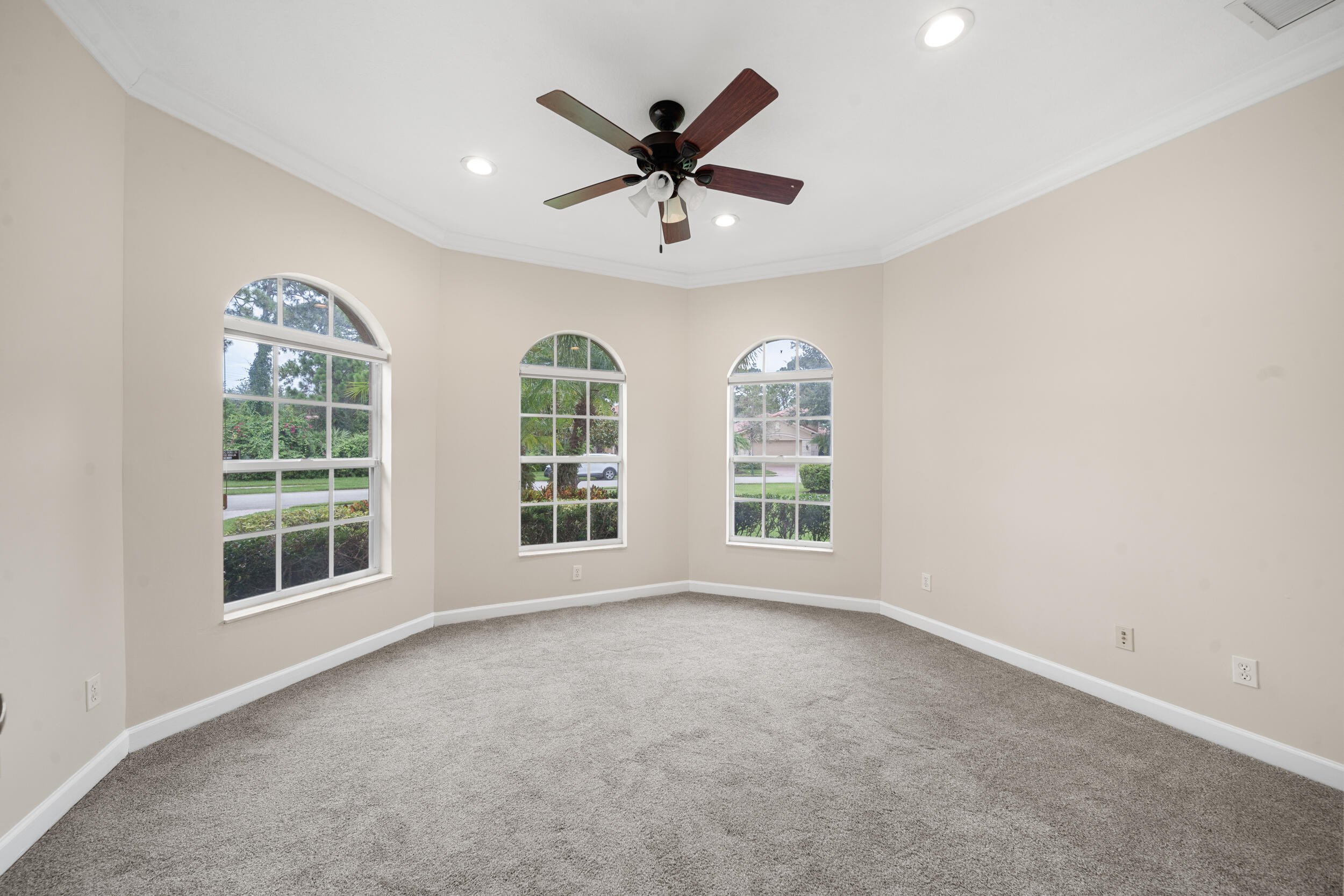9004 Pumpkin Ridge Port St. Lucie, FL 34986 - Photo 5 of 36 an empty room with windows and ceiling fan