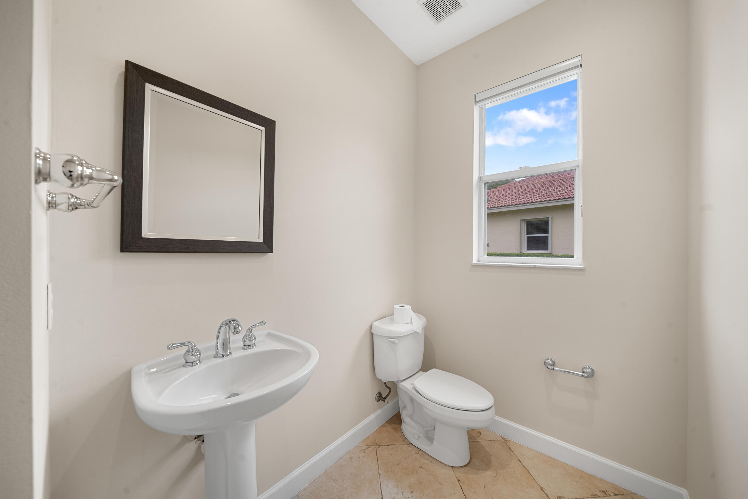 9004 Pumpkin Ridge Port St. Lucie, FL 34986 - Photo 7 of 36 a bathroom with a toilet sink and mirror