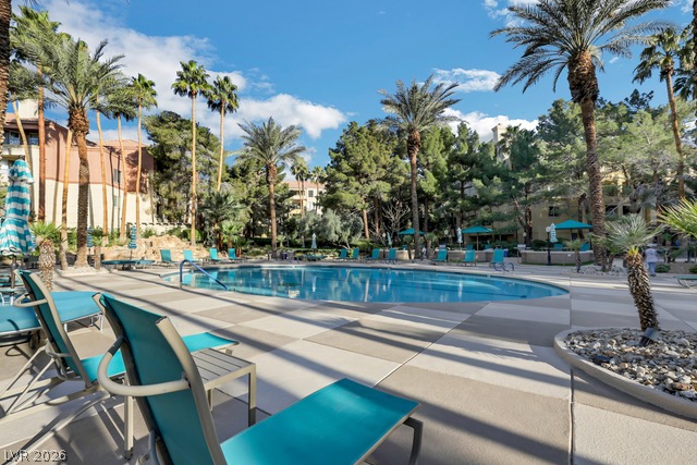 230 East Flamingo Road, Unit 435 Las Vegas, NV 89169 - Photo 2 of 15 Palm-fringed outdoor pool with generous deck space for relaxing in the sun.