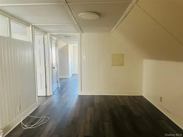 a view of a room with wooden floor and white walls