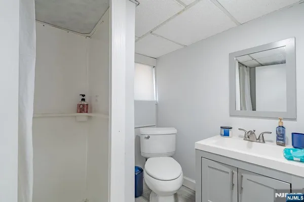a kitchen with stainless steel appliances granite countertop a refrigerator a sink dishwasher a stove and white countertops with wooden floor