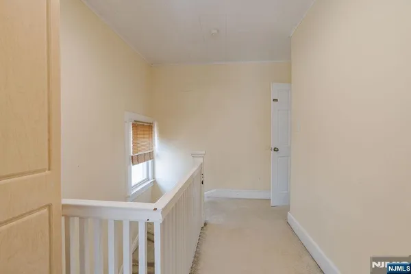 a bedroom with a bed a window and a chandelier