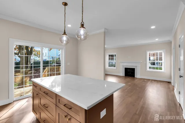 a kitchen with a stove center island a sink and a fireplace