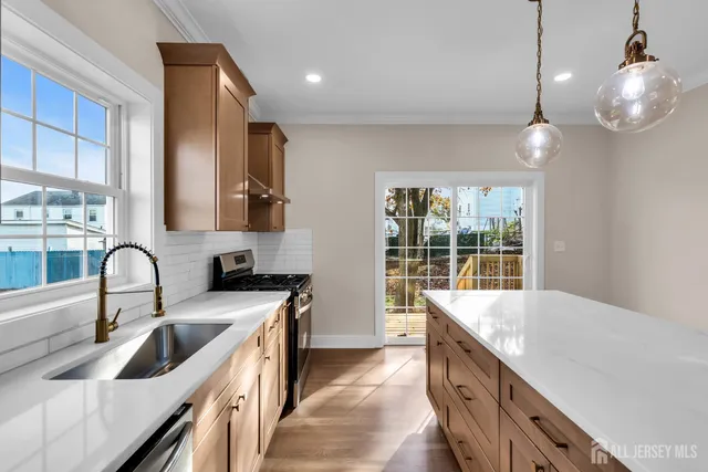 a kitchen with a sink stove and cabinets