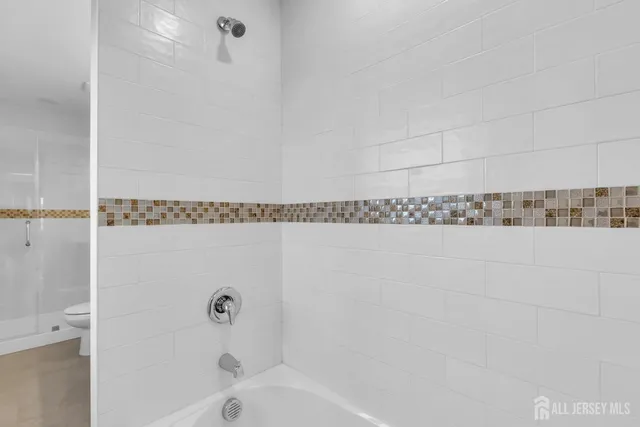 a bathroom with a bathtub and shower