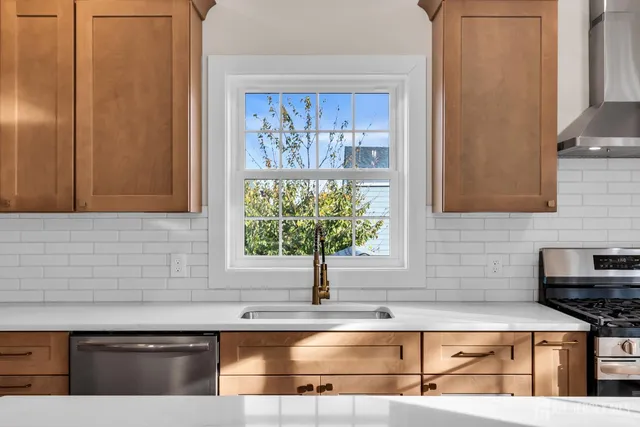 a kitchen with stainless steel appliances granite countertop a sink and a microwave