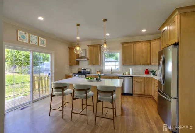 a kitchen with a table chairs refrigerator and window