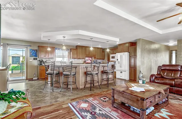 a living room with lots of furniture and kitchen view
