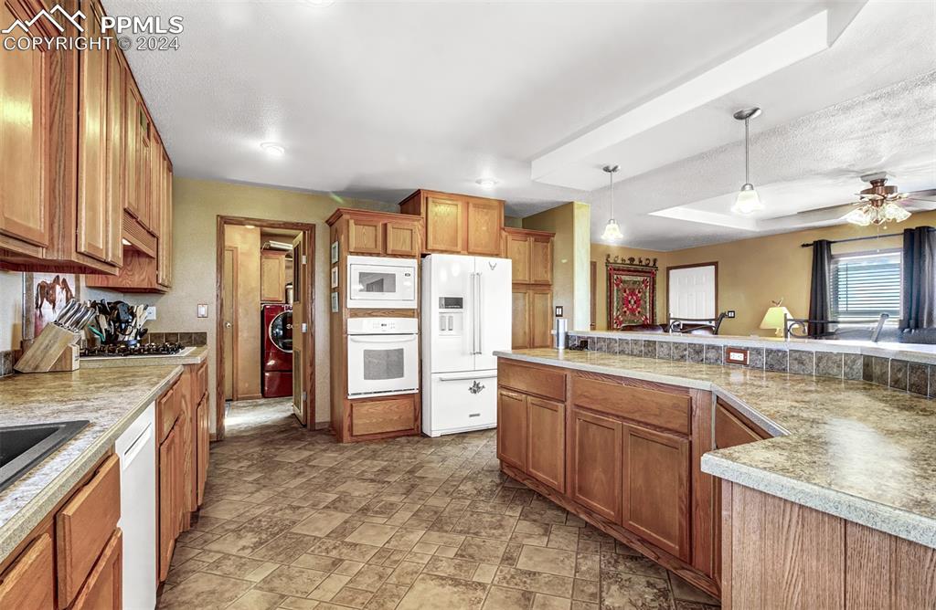 747 Harding Road Rush, CO 80833 - Photo 14 of 50 a kitchen with a sink stove and refrigerator