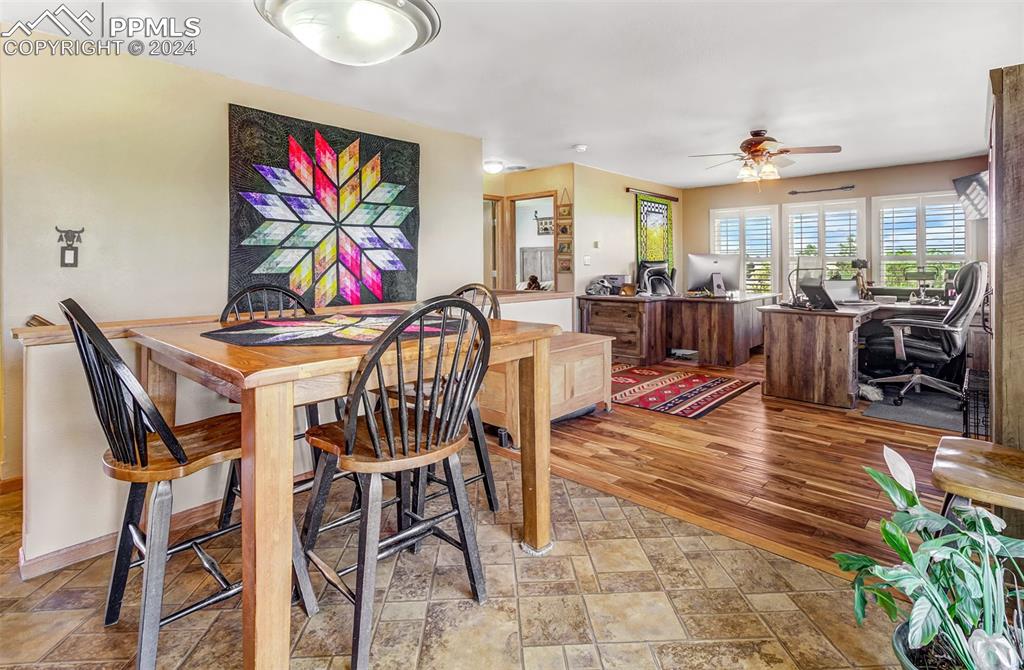 747 Harding Road Rush, CO 80833 - Photo 18 of 50 a view of a dining room with furniture a rug and wooden floor