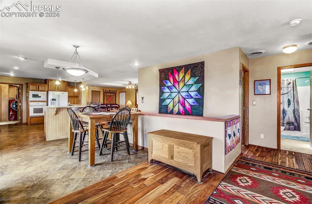 747 Harding Road Rush, CO 80833 - Photo 19 of 50 a view of a dining room with furniture one side kitchen view and wooden floor