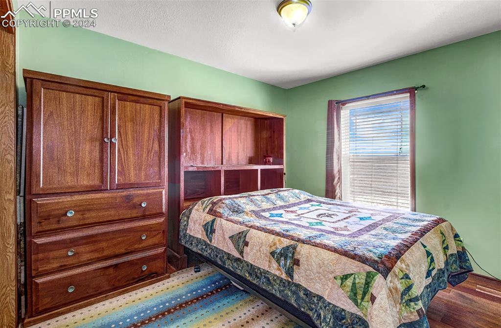 747 Harding Road Rush, CO 80833 - Photo 24 of 50 a bedroom with a bed and a dresser