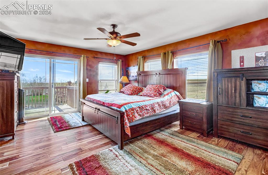 747 Harding Road Rush, CO 80833 - Photo 26 of 50 a bedroom with a bed and wooden floor