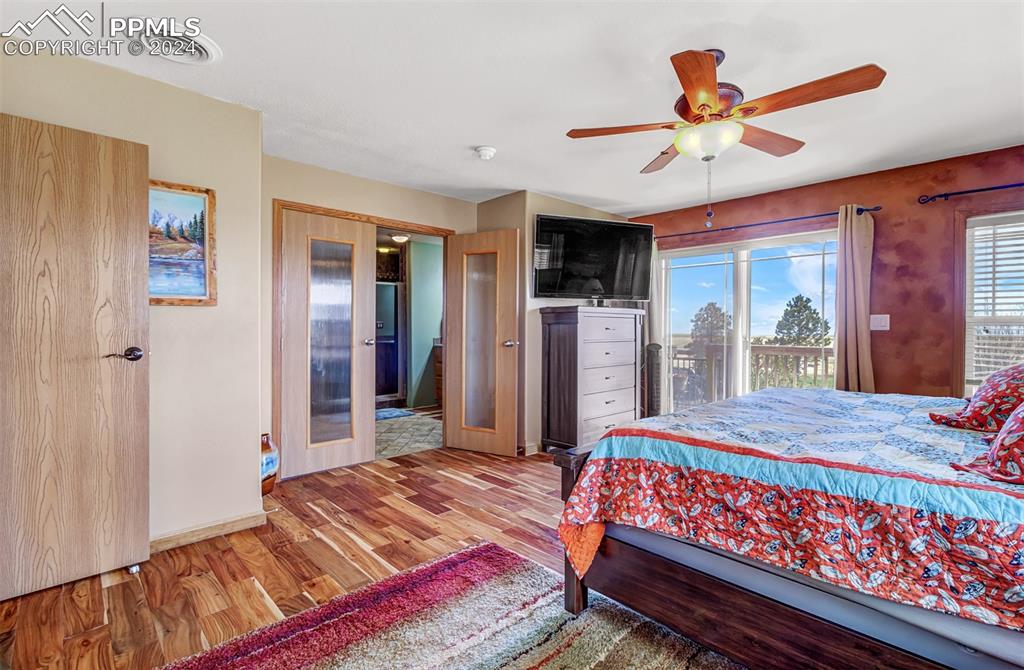747 Harding Road Rush, CO 80833 - Photo 29 of 50 a bedroom with a bed a dresser and a large window