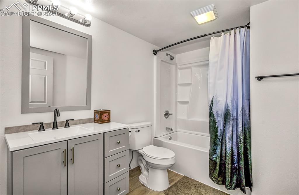 747 Harding Road Rush, CO 80833 - Photo 36 of 50 a bathroom with a sink a toilet a mirror a vanity and shower