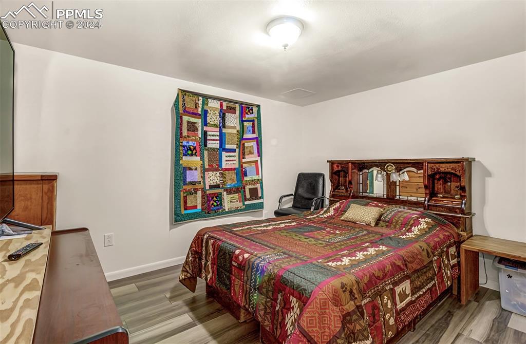 747 Harding Road Rush, CO 80833 - Photo 37 of 50 a bedroom with a bed a dresser and book shelf