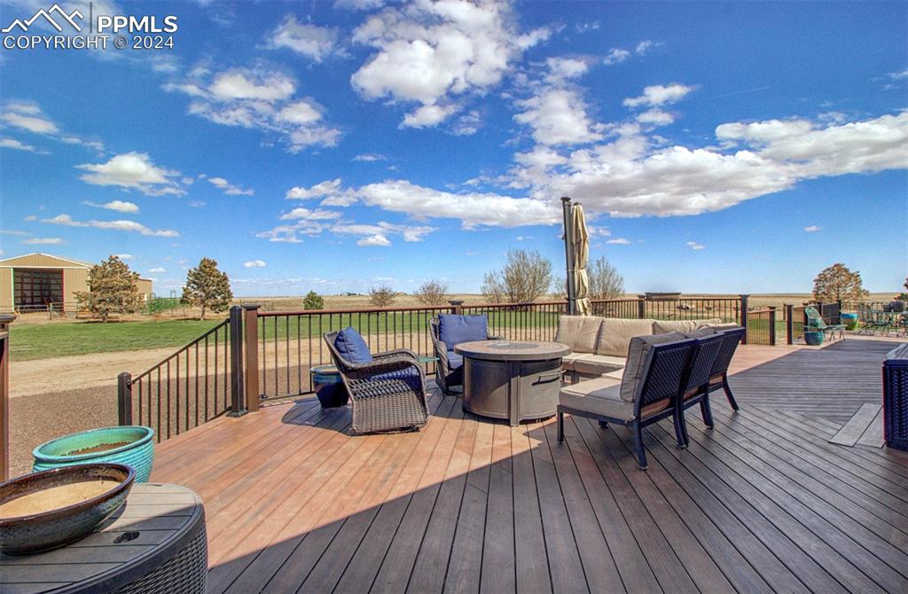 747 Harding Road Rush, CO 80833 - Photo 8 of 50 a roof deck with table and chairs and wooden floor