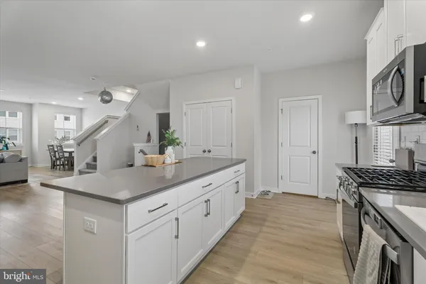 a kitchen with stainless steel appliances granite countertop a sink stove and cabinets