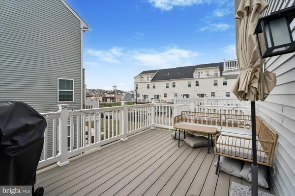 a balcony with wooden floor and furniture