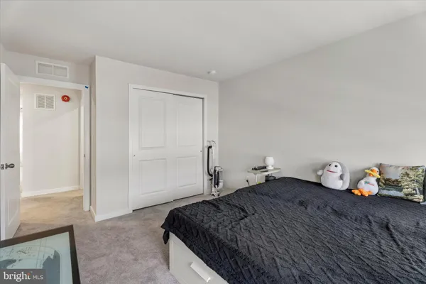 a bedroom with a bed and cabinets