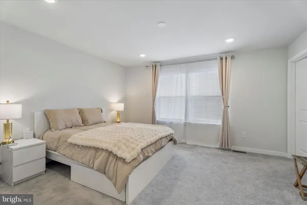 a bedroom with a large bed and a night stand