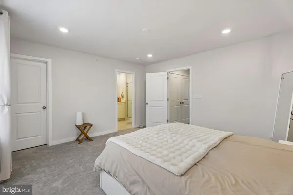 a bedroom with a bed and cabinets