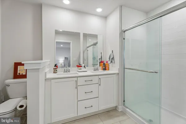 a bathroom with a sink mirror vanity and toilet