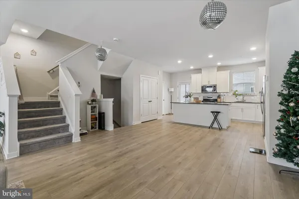 a view of a kitchen with wooden floor and electronic appliances