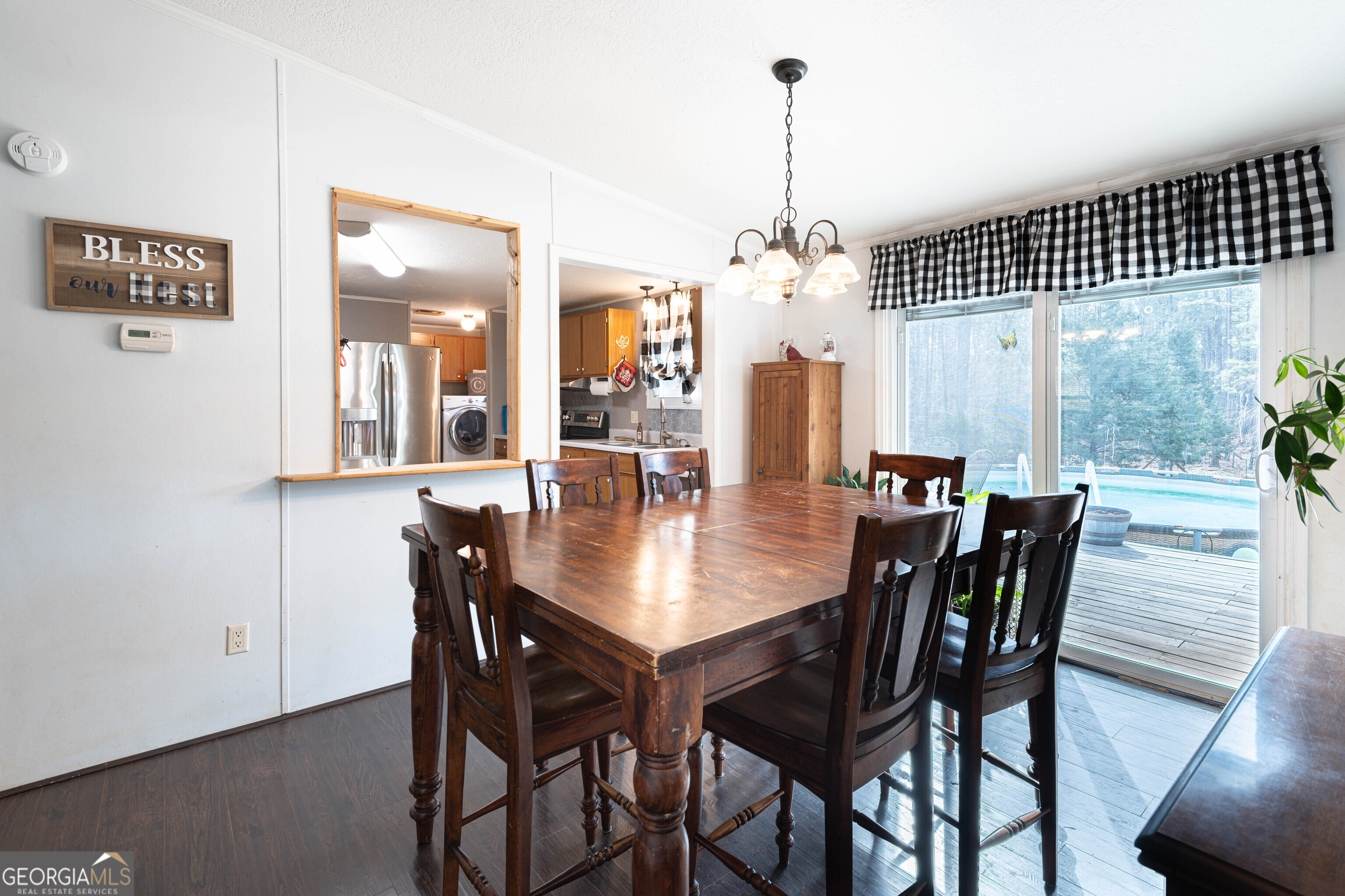 161 Cherokee Trail Forsyth, GA 31029 - Photo 9 of 32 a dining room with furniture a chandelier and wooden floor