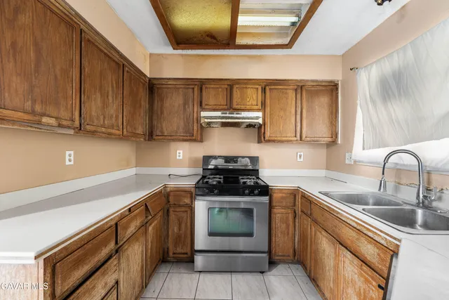 a kitchen with a refrigerator and a sink