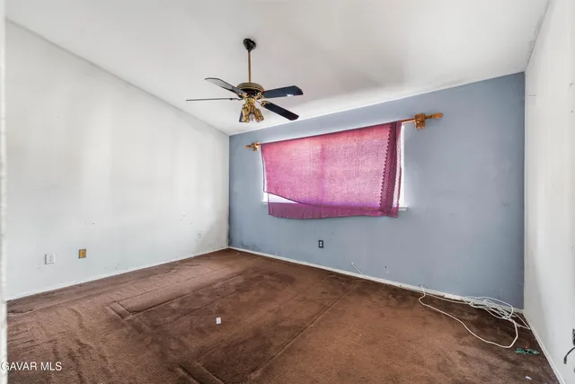 a view of empty room with ceiling fan