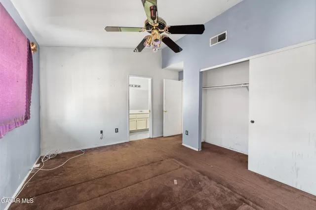 a bathroom with a granite countertop sink a toilet and a large mirror
