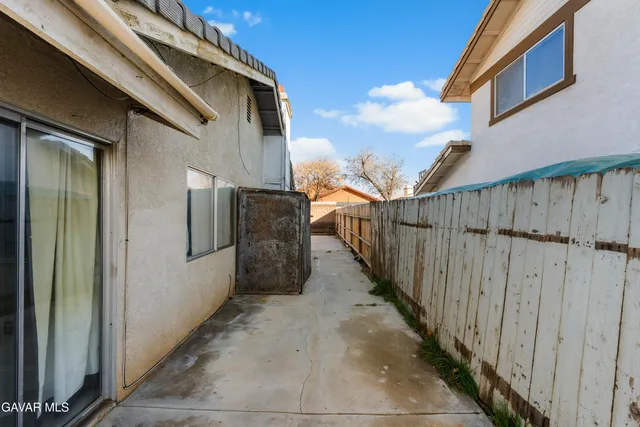 a view of a terrace with wooden floor and iron fence