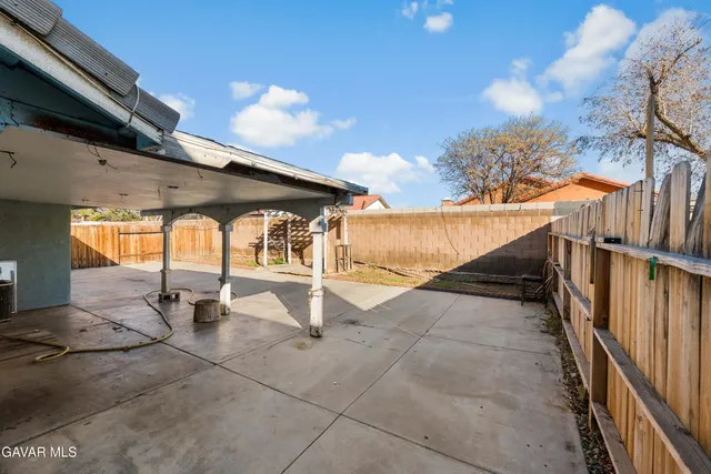 a view of a patio with a table and chairs