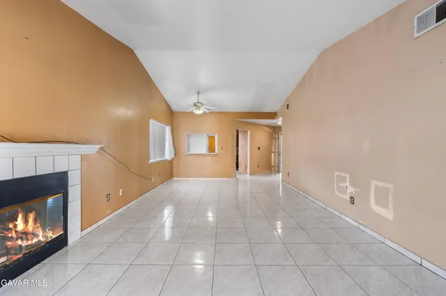 a view of an empty room and fire place