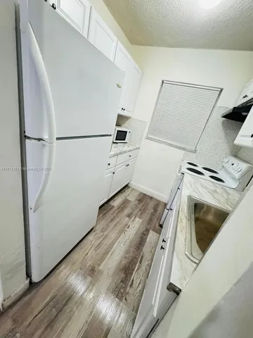 a bedroom with a bed and a white wall