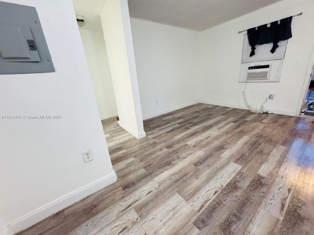 932 Northwest 5th Street, Unit 4 Miami, FL 33128 - Photo 13 of 16 a bedroom with a bed and a white wall