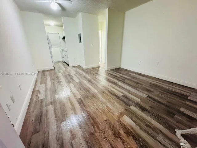 a view of a livingroom with wooden floor and staircase