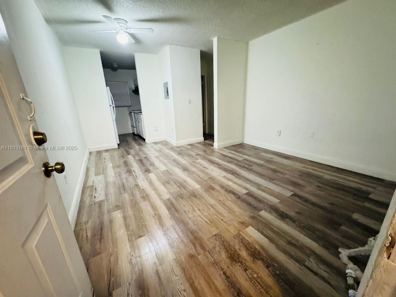 932 Northwest 5th Street, Unit 4 Miami, FL 33128 - Photo 15 of 16 a view of a livingroom with wooden floor and staircase
